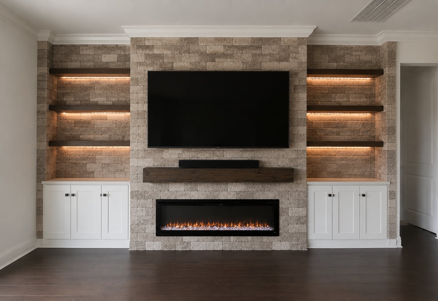 Finished living room with a custom stone feature wall and linear fireplace